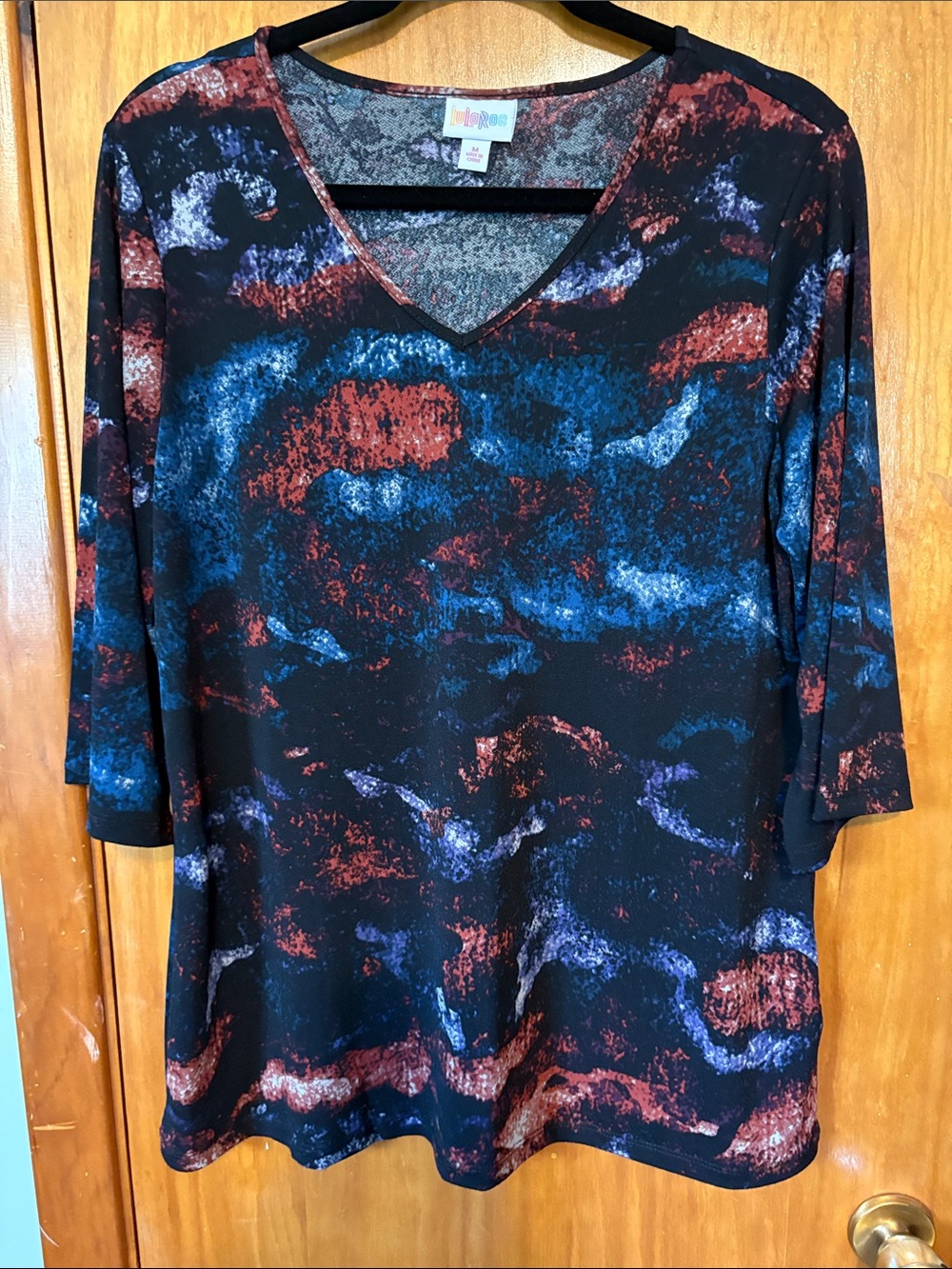 LuLaRoe Eden Black V-Neck Top with Blue & Rust Abstract Pattern - Size M